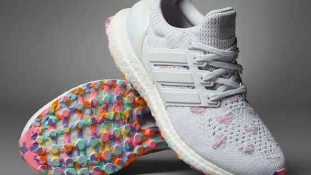 View of white and pink Adidas shoes.